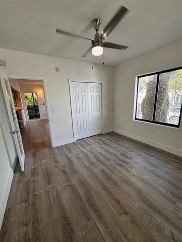 wooden floor in an empty room with a mirror