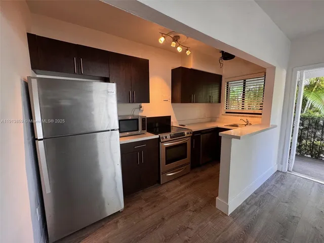 a kitchen with stainless steel appliances a refrigerator and a stove top oven