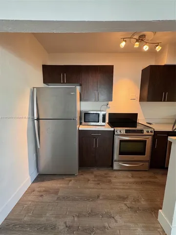 a kitchen with a refrigerator and a stove