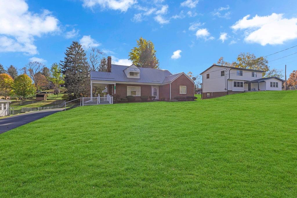 4178 South R 1022 New Brighton, PA 15066 - Photo 2 of 33 a front view of house with yard and trees in the background