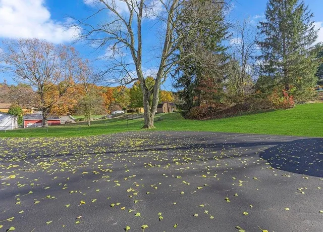 a living room with furniture a rug and a large window