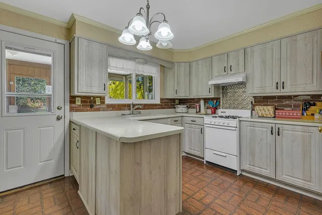 a kitchen with a sink cabinets and window