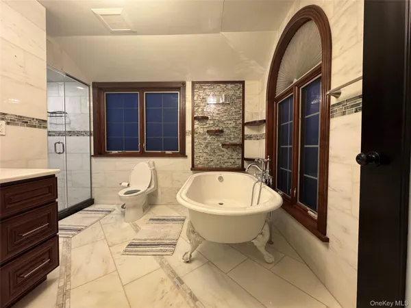 a spacious bathroom with a bathtub and a sink