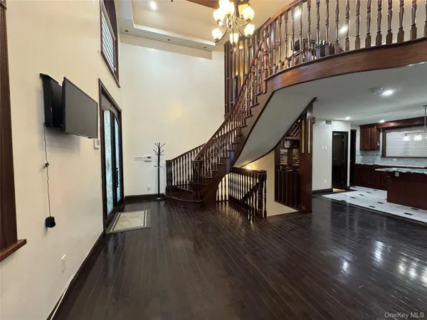 a view of entryway and hall with wooden floor