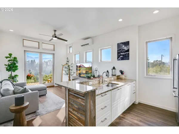 a bathroom with a granite countertop sink toilet a mirror and shower