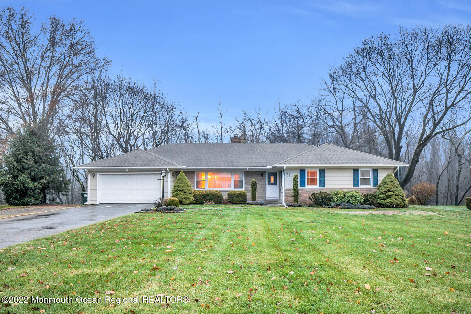 a front view of house with yard and green space