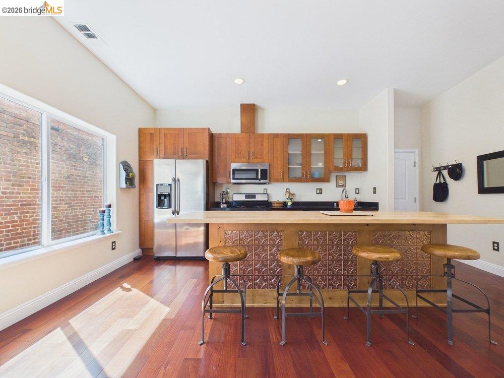 1488 14th Street, Unit A Oakland, CA 94607 - Photo 1 of 36 a large kitchen with a table and chairs in it