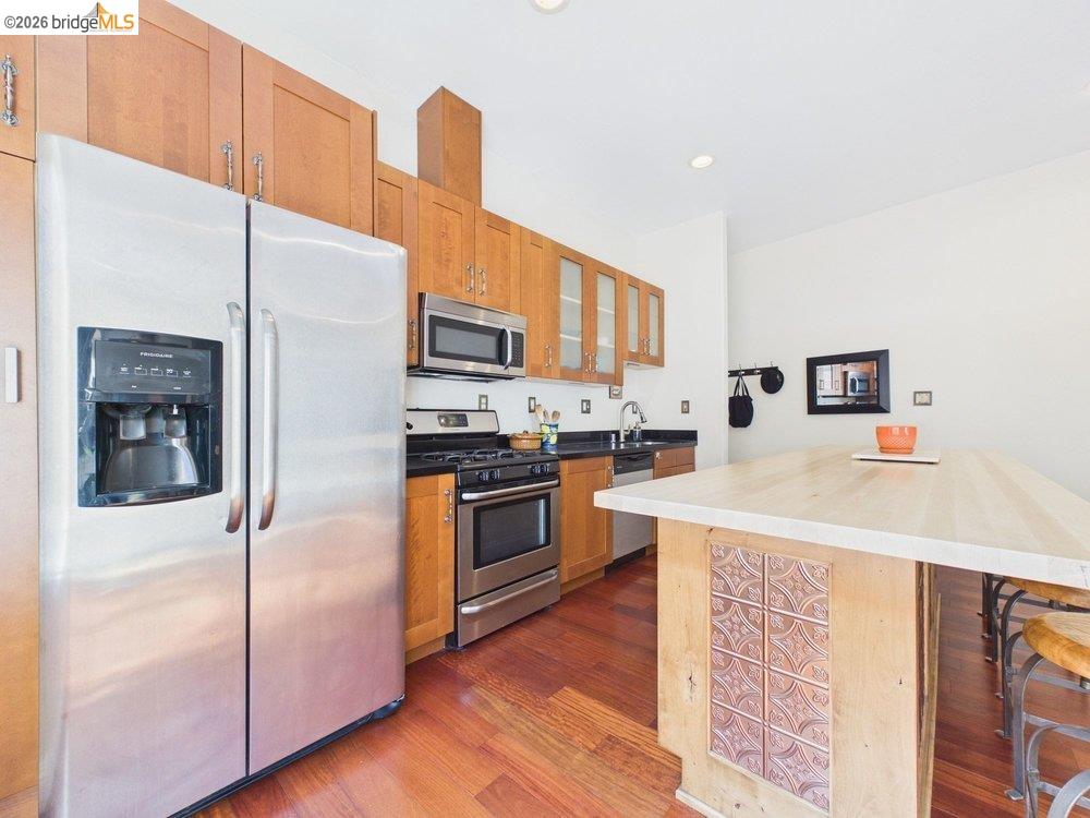 1488 14th Street, Unit A Oakland, CA 94607 - Photo 14 of 36 a kitchen with stainless steel appliances a refrigerator and a stove