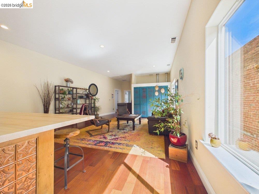 1488 14th Street, Unit A Oakland, CA 94607 - Photo 17 of 36 a living room with furniture a potted plant and a large window