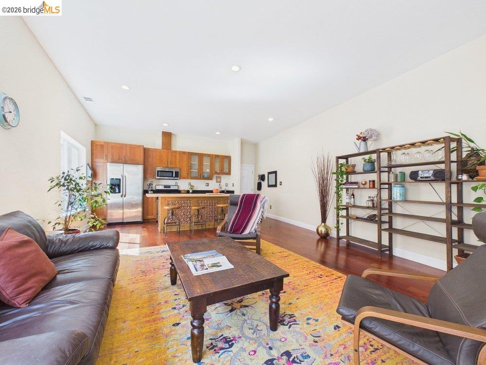 1488 14th Street, Unit A Oakland, CA 94607 - Photo 18 of 36 a living room with furniture a rug and a bookshelf