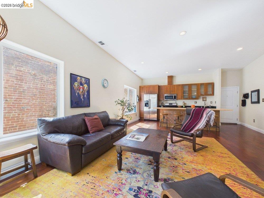 1488 14th Street, Unit A Oakland, CA 94607 - Photo 20 of 36 a living room with furniture or couch and a wooden floor
