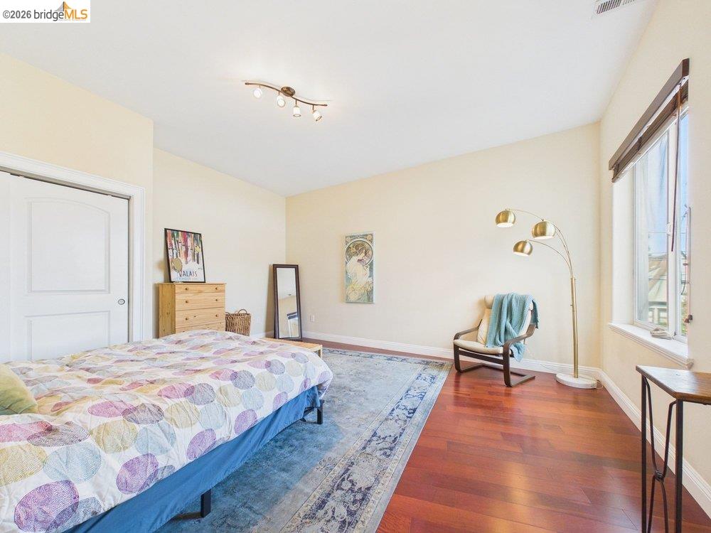 1488 14th Street, Unit A Oakland, CA 94607 - Photo 23 of 36 a bedroom with a bed and a couch