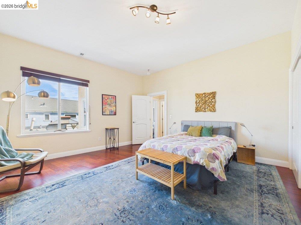 1488 14th Street, Unit A Oakland, CA 94607 - Photo 25 of 36 a bedroom with a bed and a painting on the wall