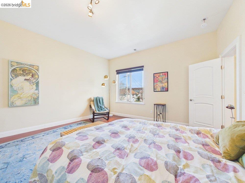 1488 14th Street, Unit A Oakland, CA 94607 - Photo 26 of 36 a bedroom with a bed and a painting on the wall