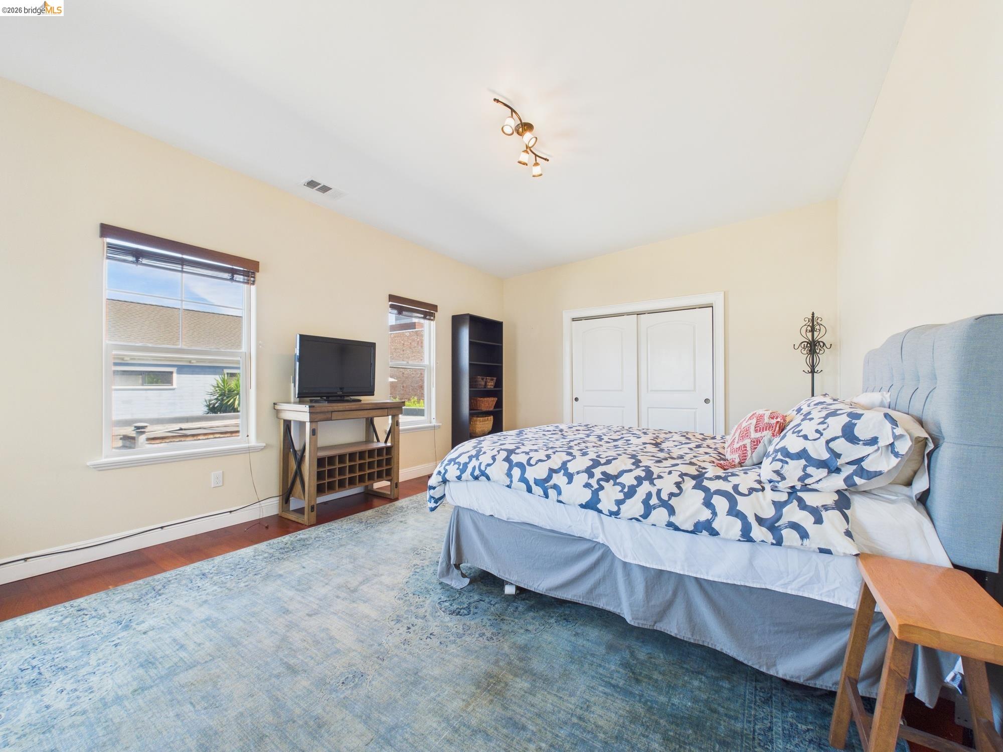 1488 14th Street, Unit A Oakland, CA 94607 - Photo 30 of 36 a bedroom with a bed and a flat screen tv