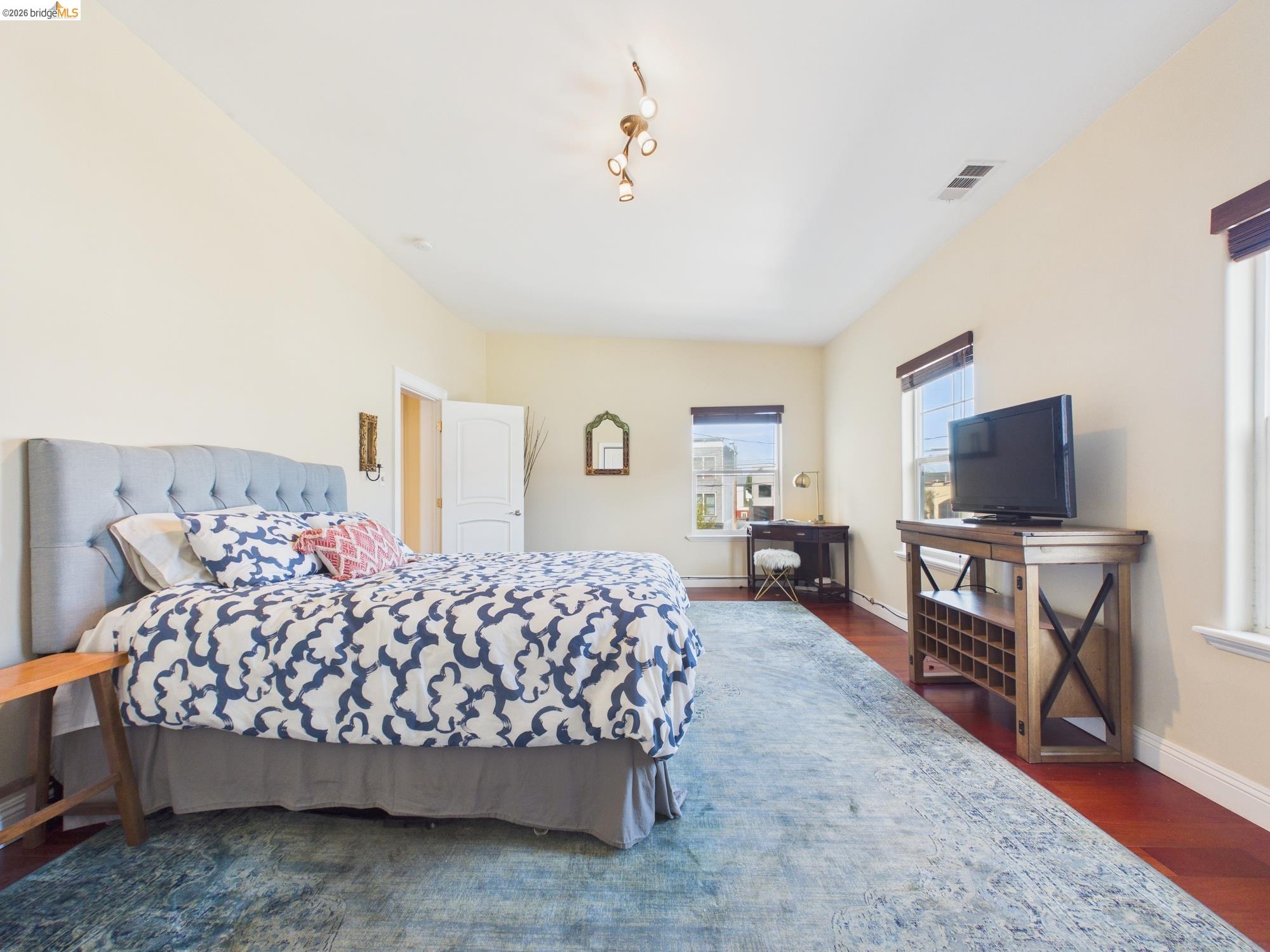 1488 14th Street, Unit A Oakland, CA 94607 - Photo 32 of 36 a bedroom with a bed and flat screen tv