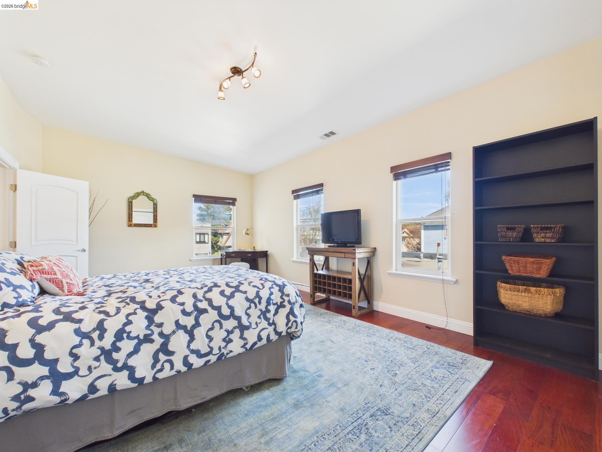 1488 14th Street, Unit A Oakland, CA 94607 - Photo 33 of 36 a bedroom with a bed and a television