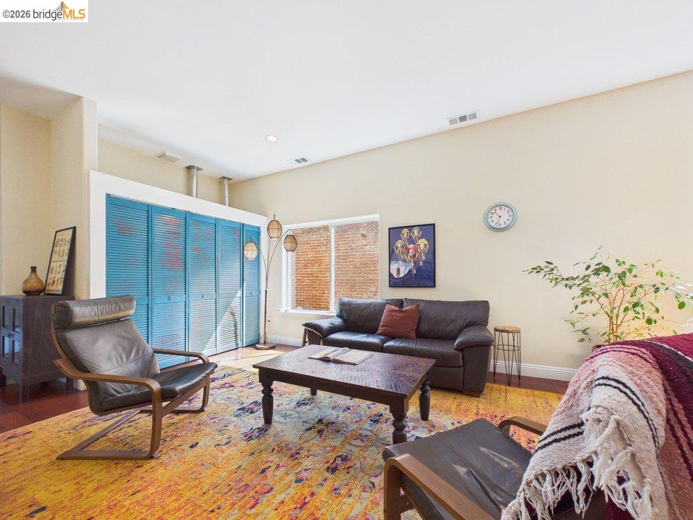 1488 14th Street, Unit A Oakland, CA 94607 - Photo 5 of 36 a living room with furniture and a rug