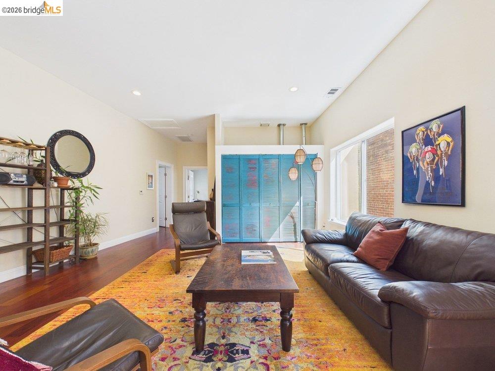 1488 14th Street, Unit A Oakland, CA 94607 - Photo 6 of 36 a living room with furniture a rug and a wooden floor