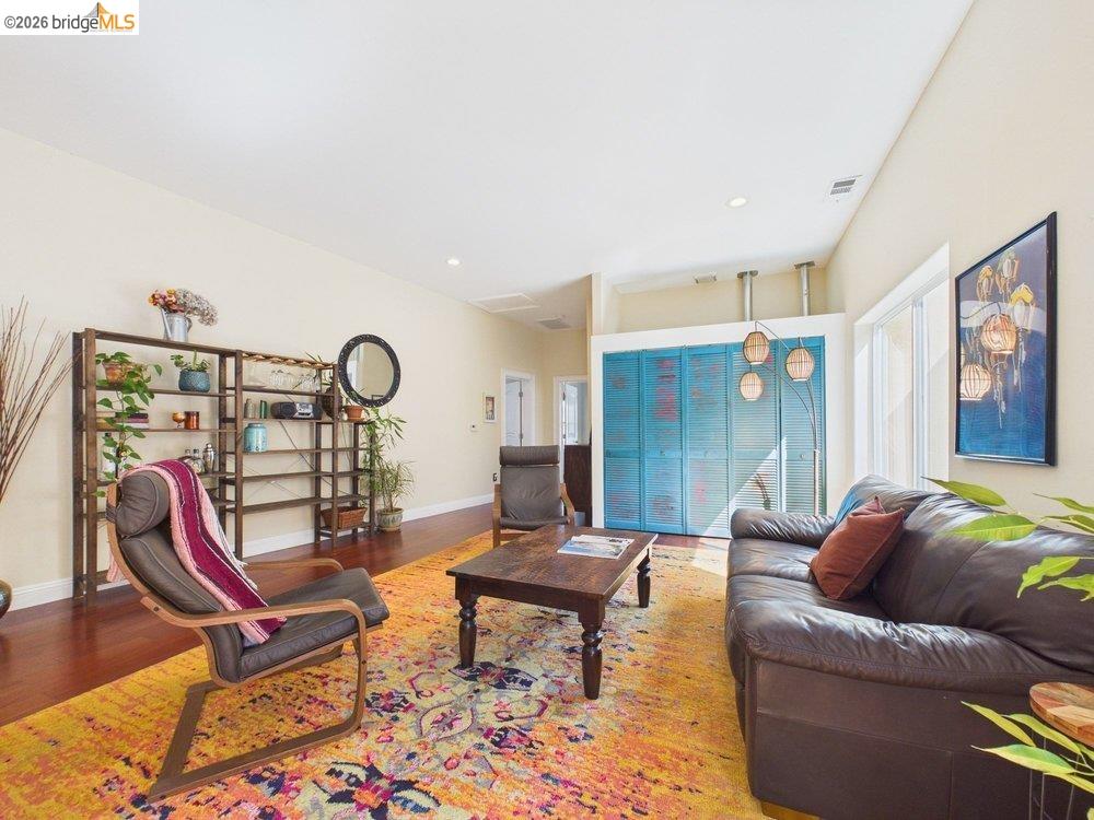 1488 14th Street, Unit A Oakland, CA 94607 - Photo 7 of 36 a living room with furniture a rug and white walls