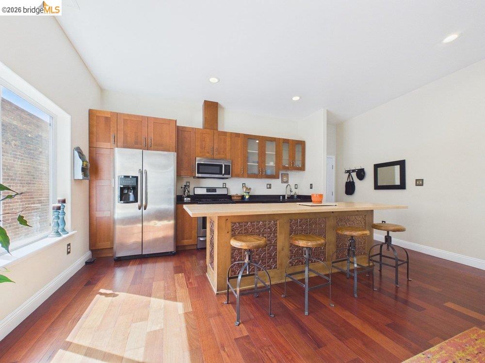 1488 14th Street, Unit A Oakland, CA 94607 - Photo 8 of 36 a living room with stainless steel appliances furniture and a kitchen view