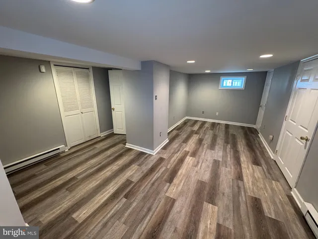 a view of an empty room and wooden floor