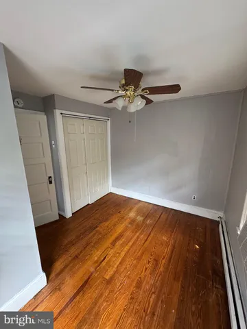 a view of a room with wooden floor and staircase