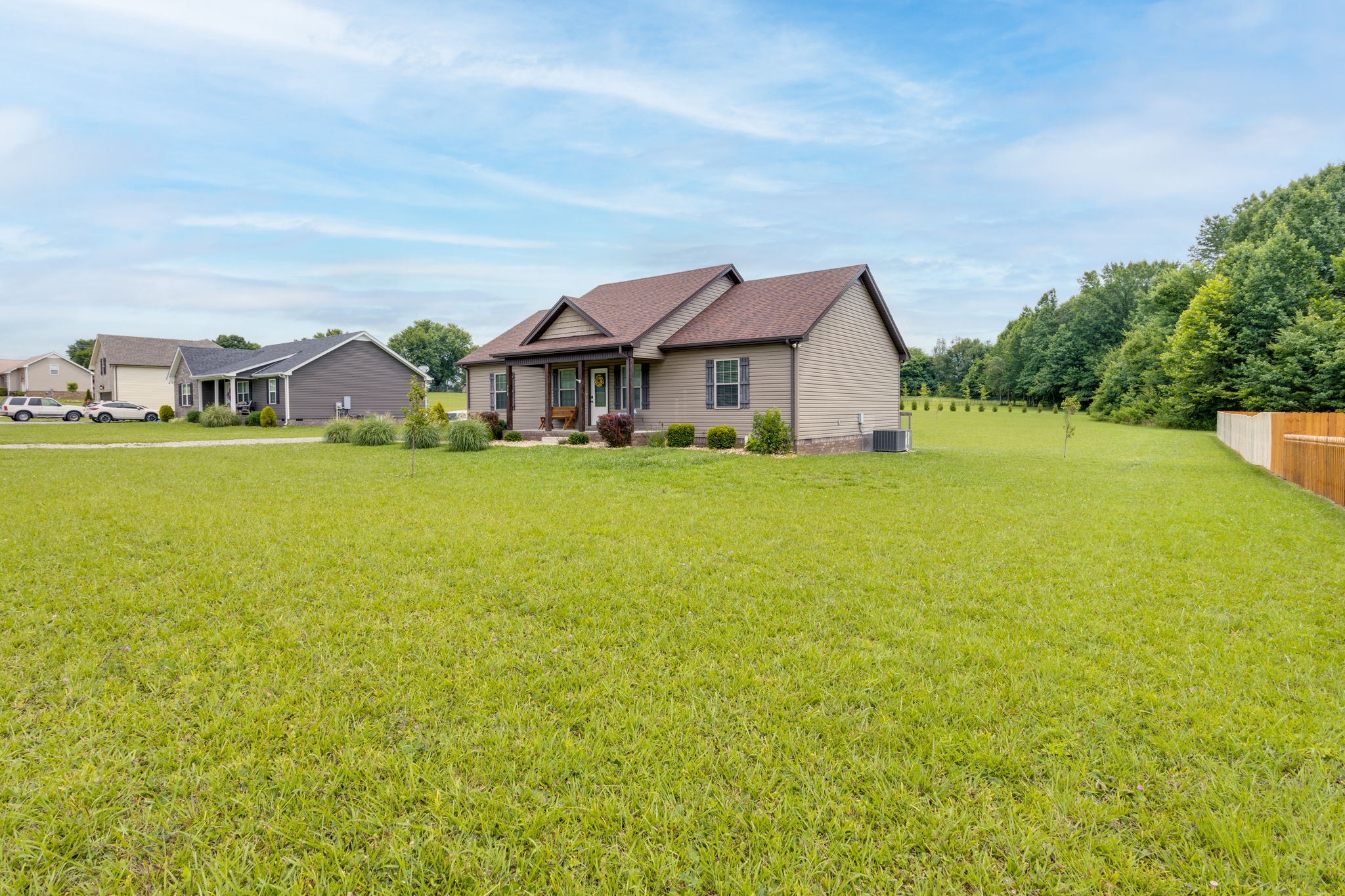 330 Tom Ferrell Road Portland, TN 37148 - Photo 3 of 29 a view of a big house with a big yard and large trees