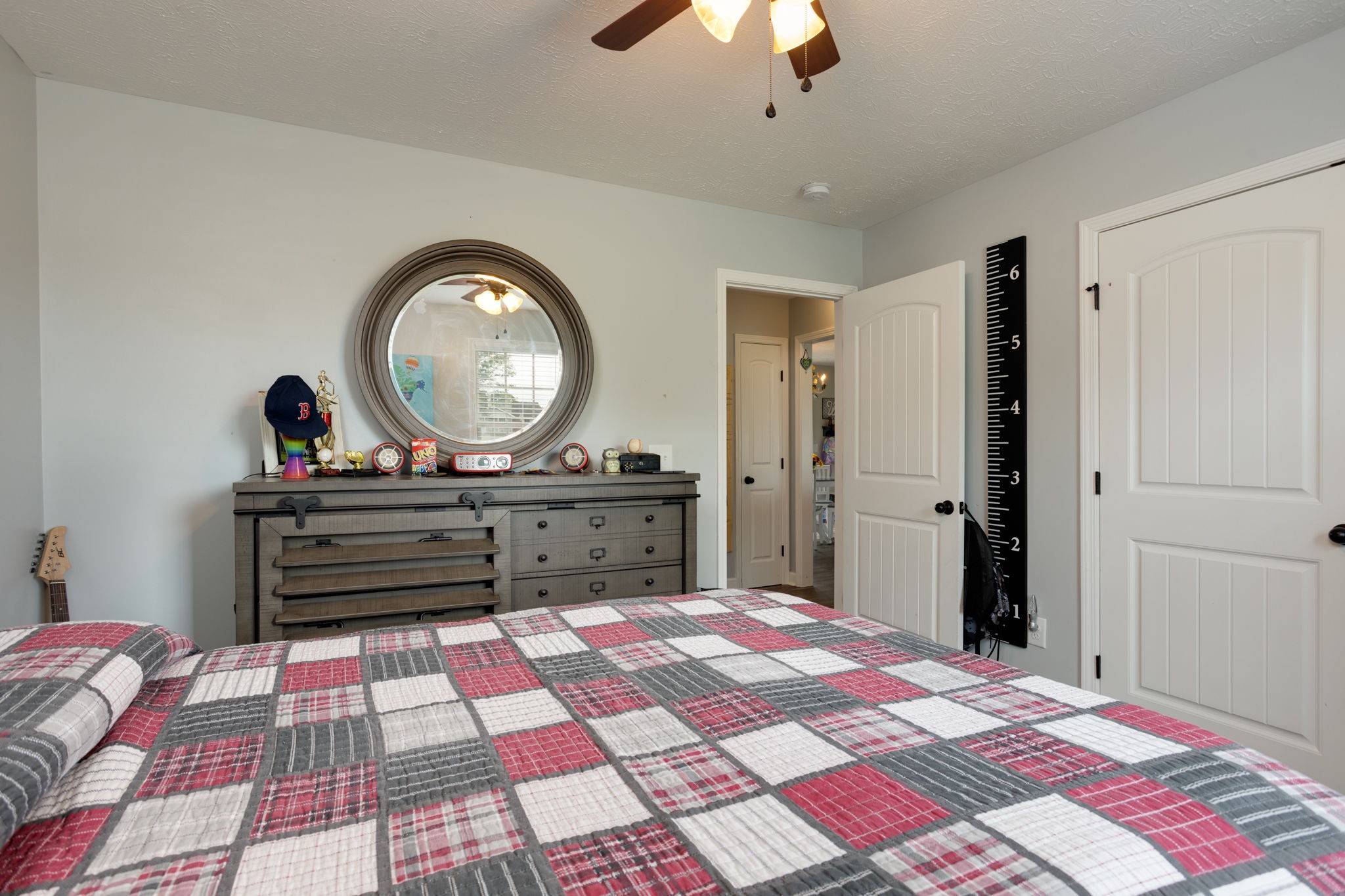 330 Tom Ferrell Road Portland, TN 37148 - Photo 24 of 29 a bedroom with a bed and a chandelier
