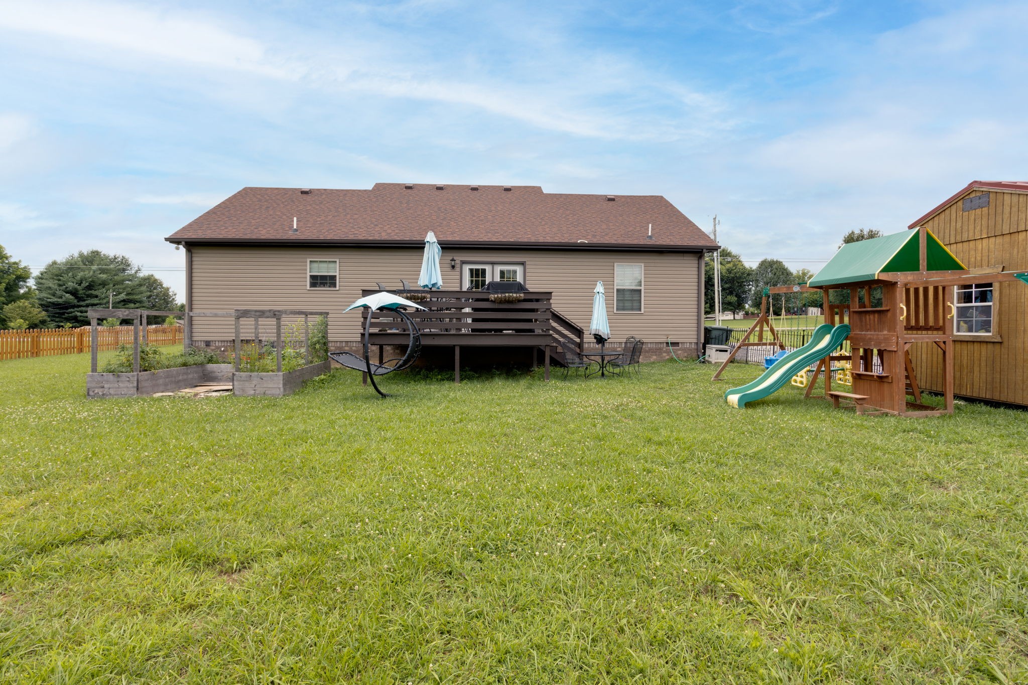 330 Tom Ferrell Road Portland, TN 37148 - Photo 26 of 29 a backyard of a house with childrens swings and slides