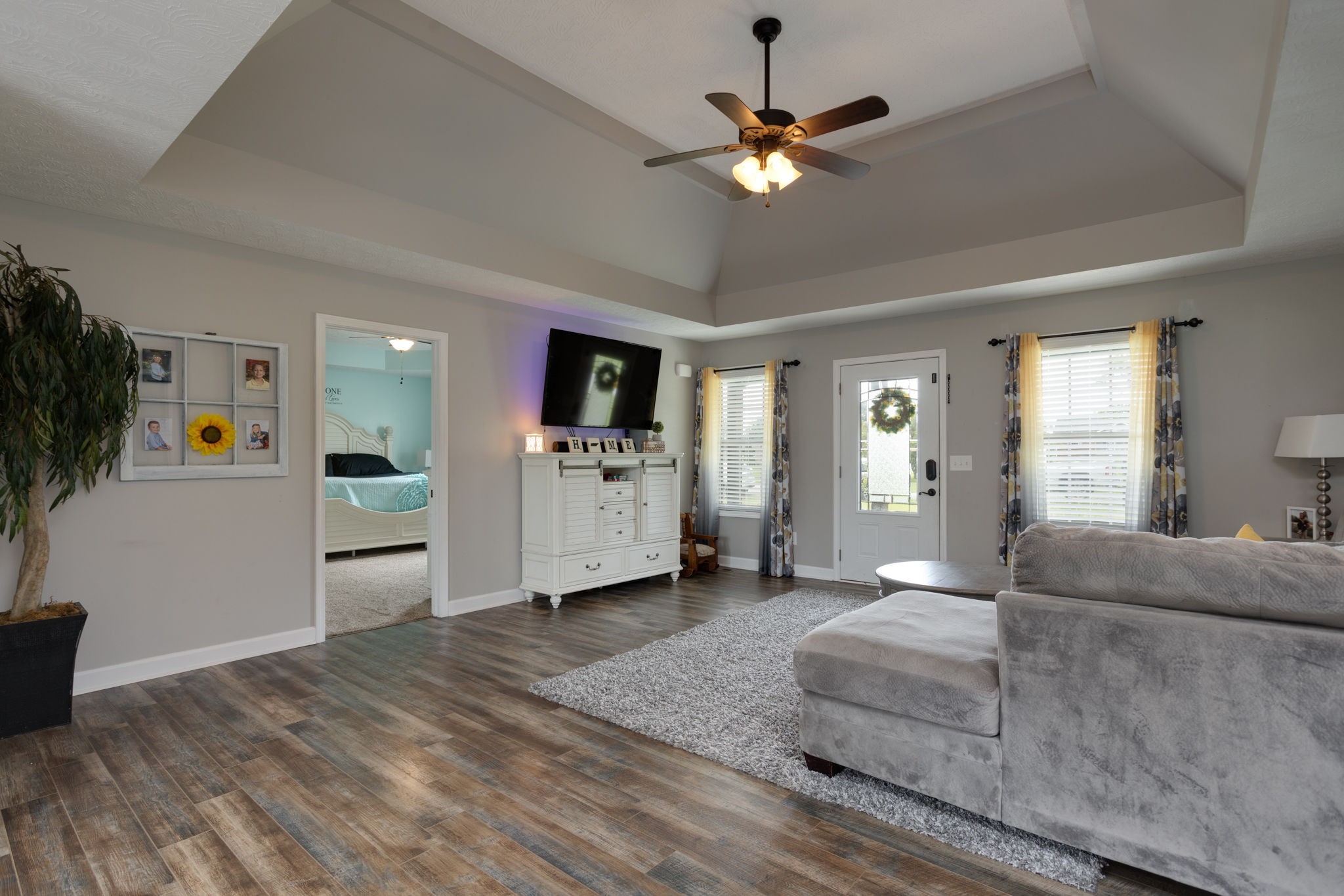330 Tom Ferrell Road Portland, TN 37148 - Photo 9 of 29 a spacious bedroom with a bed and a chandelier