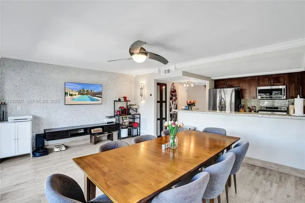 a view of a dining room with furniture and wooden floor