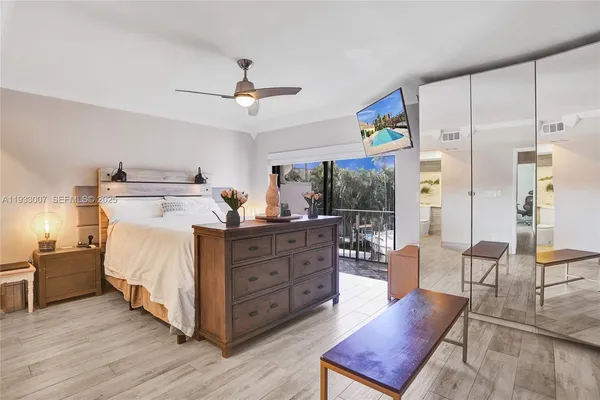 a bedroom with a large bed and a large window