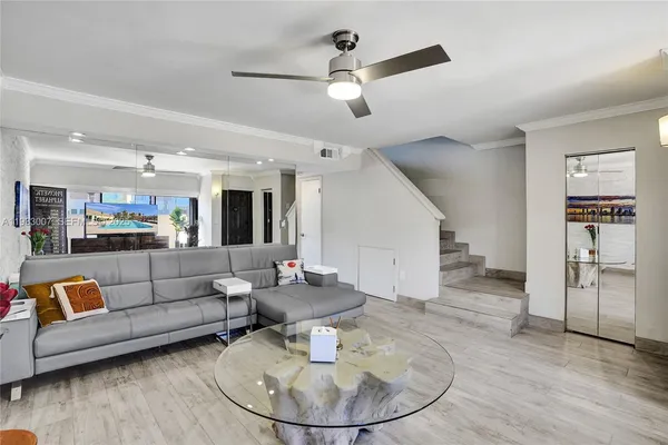 a living room with furniture and wooden floor