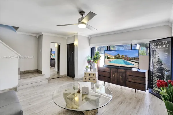 a kitchen with stainless steel appliances kitchen island granite countertop a refrigerator a stove and a wooden floors