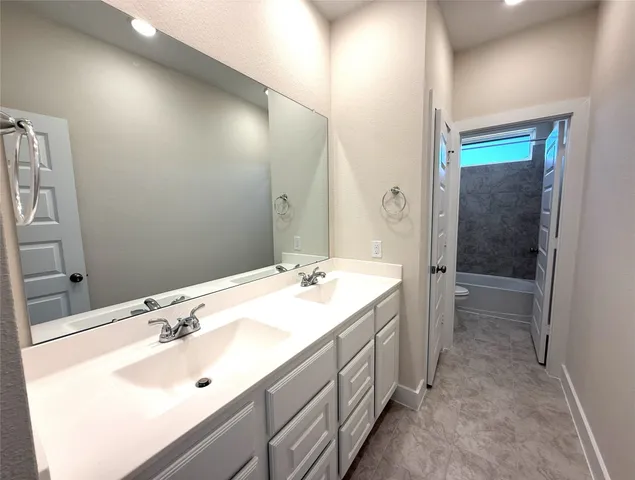 a bathroom with a bathtub and a toilet