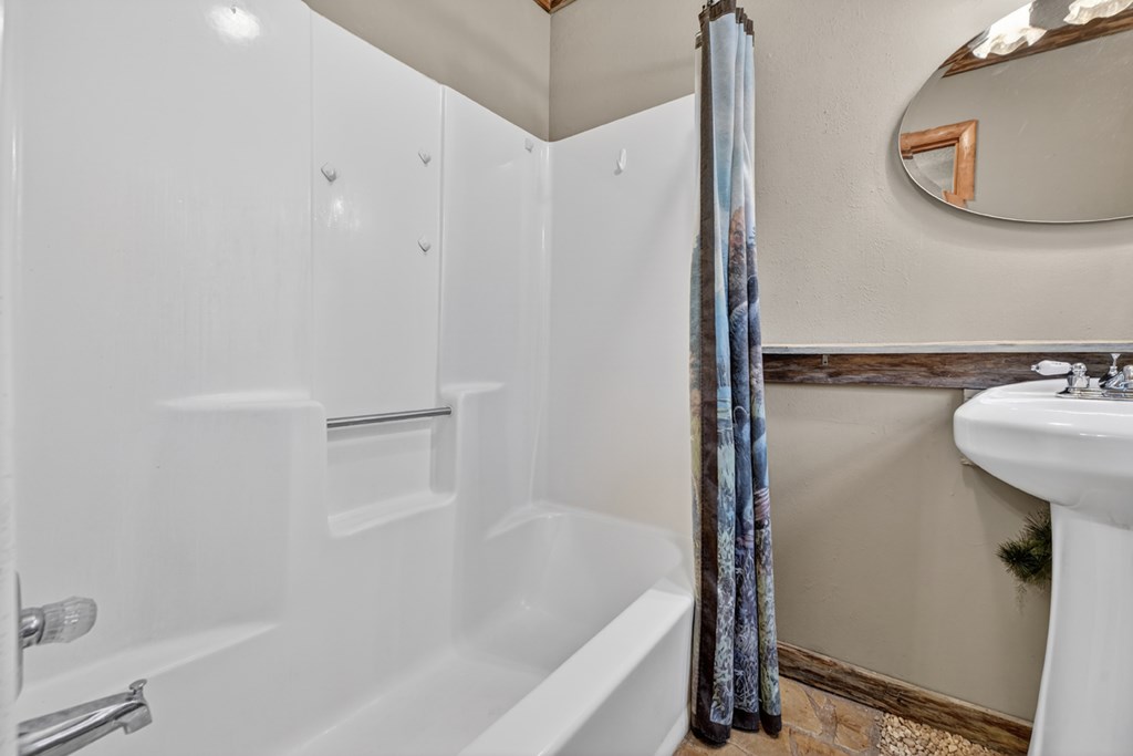 111 Candlewood Lane Blue Ridge, GA 30513 - Photo 57 of 57 a bathroom with a sink a mirror and a bathtub
