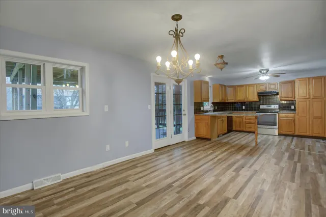 a view of a kitchen with a sink and cabinets