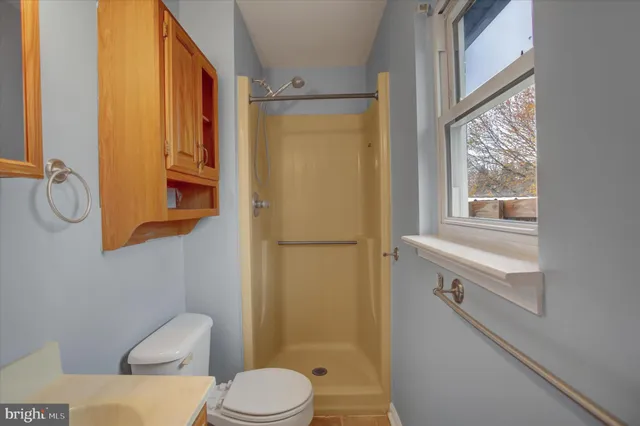 a bathroom with a toilet a sink and a shower