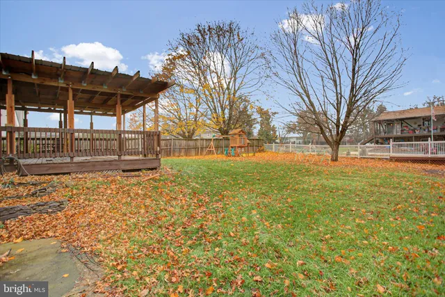 a backyard of a house with barbeque oven and outdoor seating