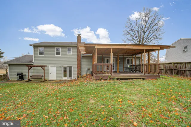 a view of a house with pool and chairs