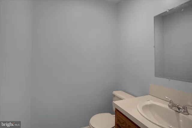 a bathroom with a sink toilet and mirror