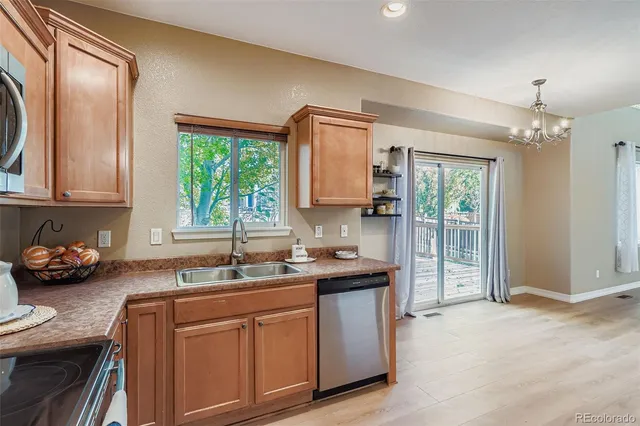 a kitchen with stainless steel appliances granite countertop a sink stove and cabinets
