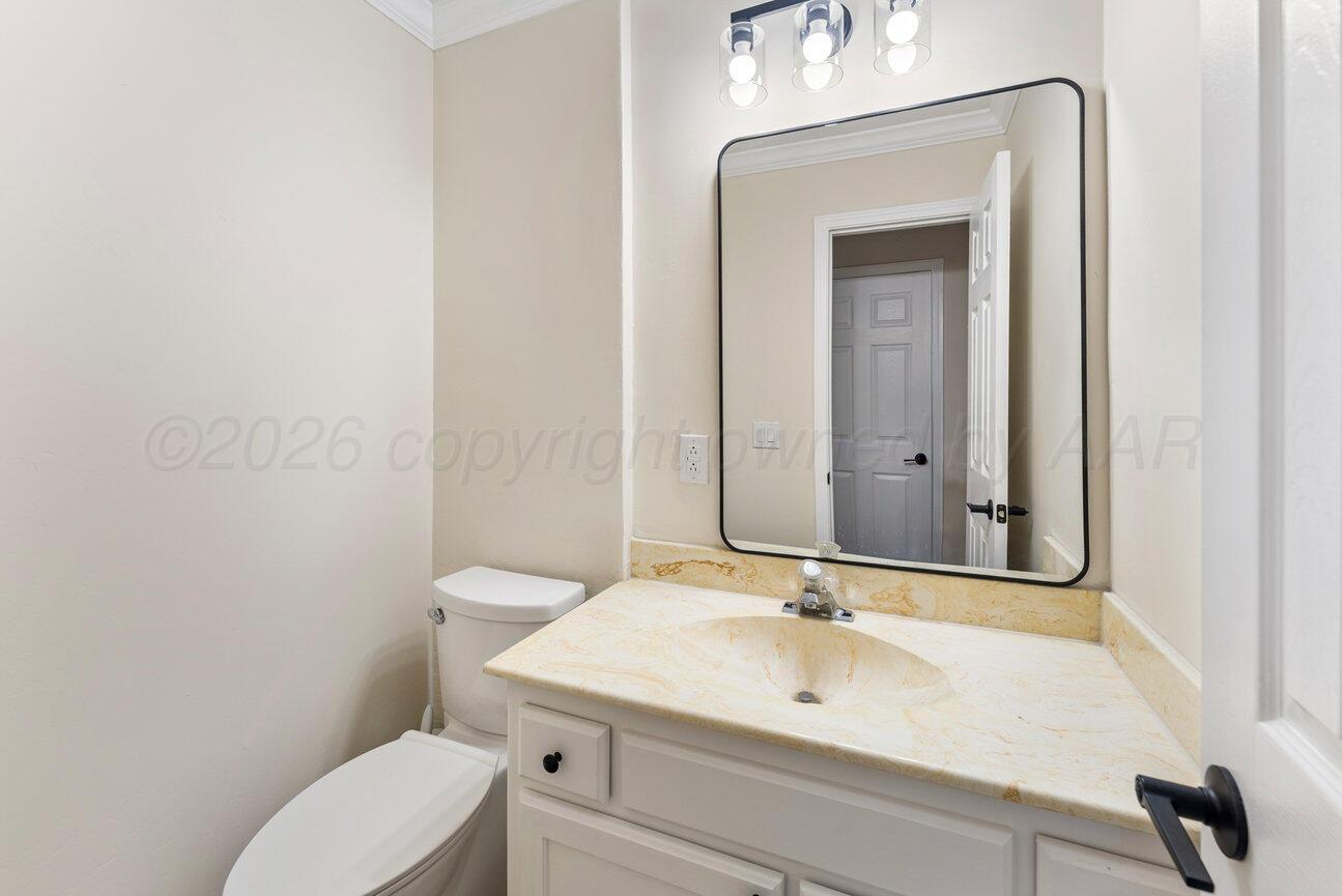 7204 Southwest 39th Avenue Amarillo, TX 79109 - Photo 47 of 51 a bathroom with a sink a toilet and mirror
