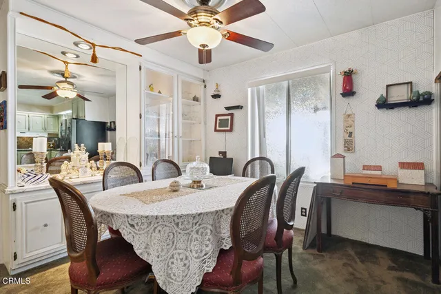 a view of a a dining room with furniture window and wooden floor