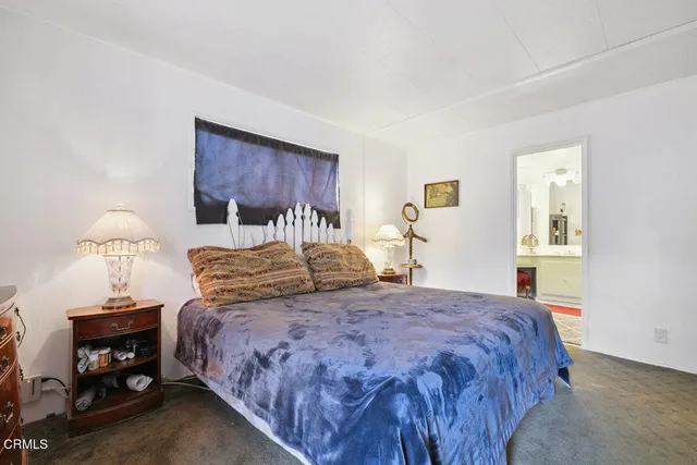 a bedroom with a bed and a lamp