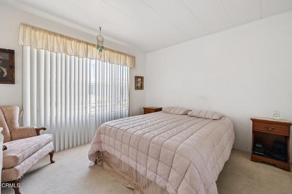 1550 Rory Lane, Unit 82 Simi Valley, CA 93063 - Photo 22 of 27 a bedroom with a bed and a couch