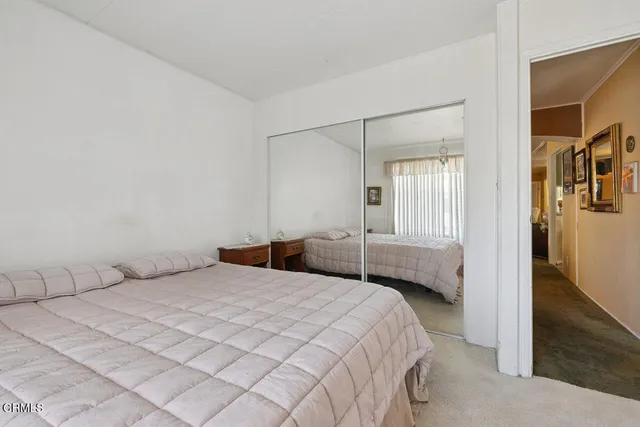 a bedroom with a bed and a walk in closet