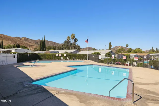 a view of a swimming pool with a table and chairs
