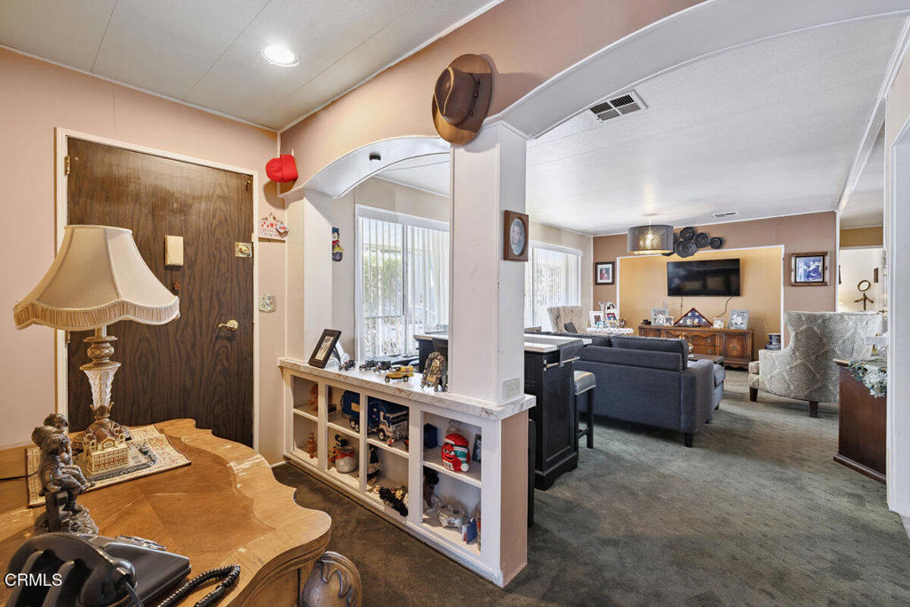 1550 Rory Lane, Unit 82 Simi Valley, CA 93063 - Photo 7 of 27 a living room with furniture a flat screen tv and a table
